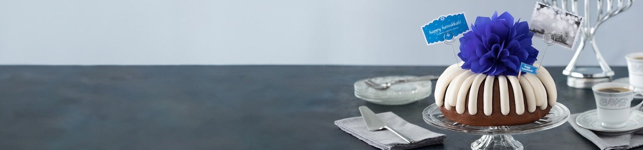 Festive Bundt Cake with a blue bow and happy hanukkah card