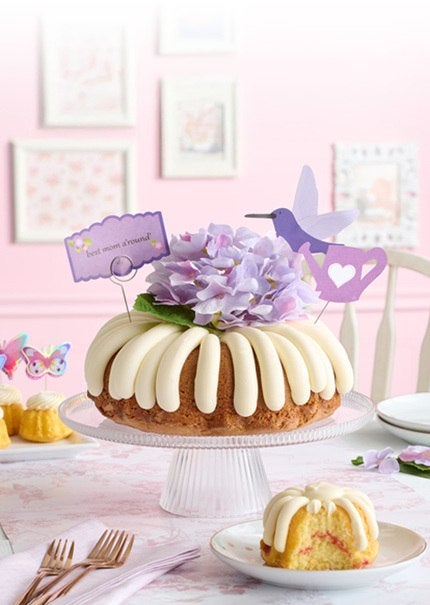 Table featuring Butterflies Bundtinis and Best Mom A'round Bundt cake.
