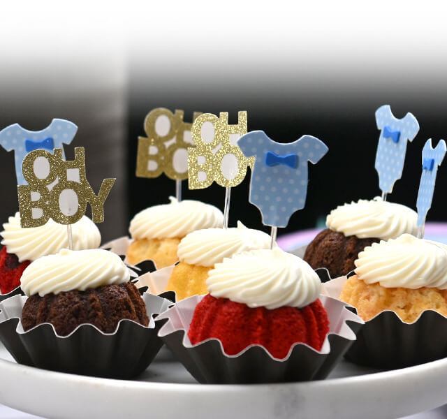 Bundtinis on a cake tray decorated with 