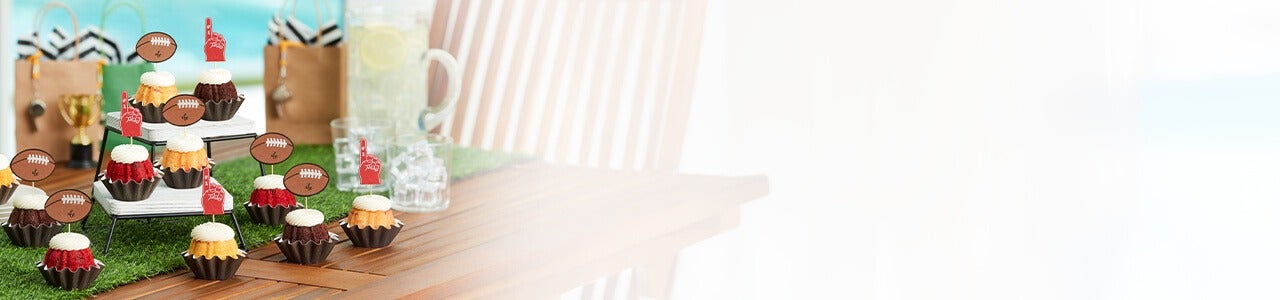 Bundtinis with baseball and glove toppers on a table
