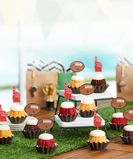 Bundtinis with baseball and glove toppers on a table