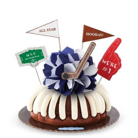 MVP Hockey Bundt Cake with cream cheese frosting, blue and white tissue paper flower, hockey stick decoration, sports pennants including All Star and Hooray, We're #1 foam finger, and MVP sign for hockey celebrations and sports team victories.