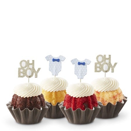 Four baby shower Bundtinis in variety of flavors with frosting and blue Oh Boy themed toppers for boy baby shower.