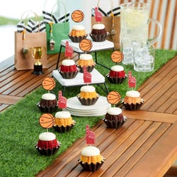 Mini bundt cakes topped with frosting in assorted flavors with a basketball topper and a #1 foam finger.