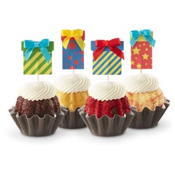 Cupcake-sized mini cakes with frosting and birthday present toppers with different celebratory designs.