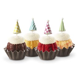 Dotted party hats top the frosting covered mini bundt cakes.