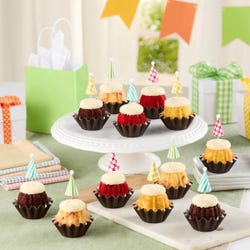 Dotted party hats top the frosting covered mini bundt cakes.