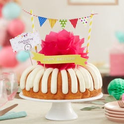 A bundt cake with a banner that says Happy Birthday