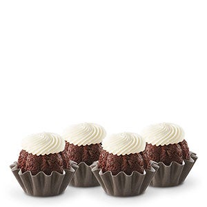 Four Chocolate Chocolate Chip Bundtinis sitting in a row.