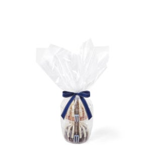 Two Bundtlets stacked on top of each other wrapped in cellophane and tied together with a navy-blue bow