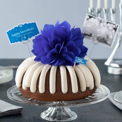 Hanukkah decorated bundt cake with an indigo colored bow.