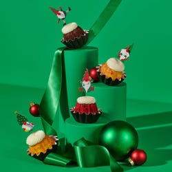 Holiday Gnome Bundtinis® topped with frosting and decorated with Christmas themed gnomes.