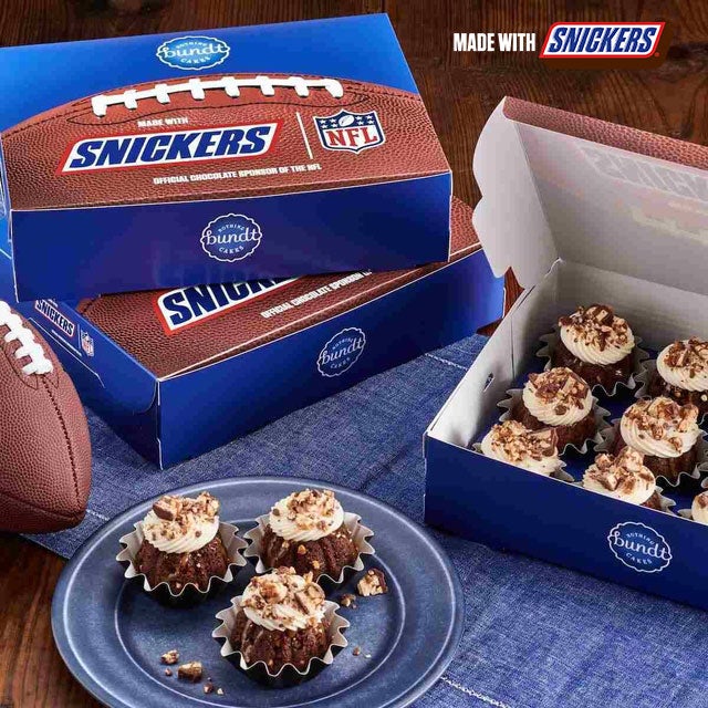 Snickers flavor, mini Bundt cakes crowned with cream cheese and snicker pieces - Shop Bundtinis