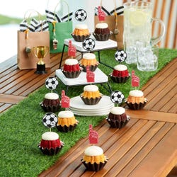 Mini bundt cakes topped with frosting in assorted flavors with a soccer ball topper and a #1 foam finger.