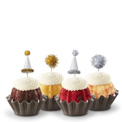 Bundtinis® topped with frosting and decorated with gold and silver hats and pom poms.