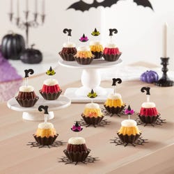 Last Chance! Mini bundt cakes with frosting and topped with a witch hat and a witch boot. 