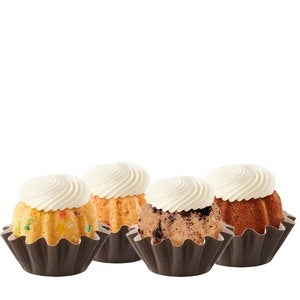 Four Bundtinis sitting in a row. Confetti, Strawberries & Cream, Oreo Cookies & Cream, and Pumpkin Spice.